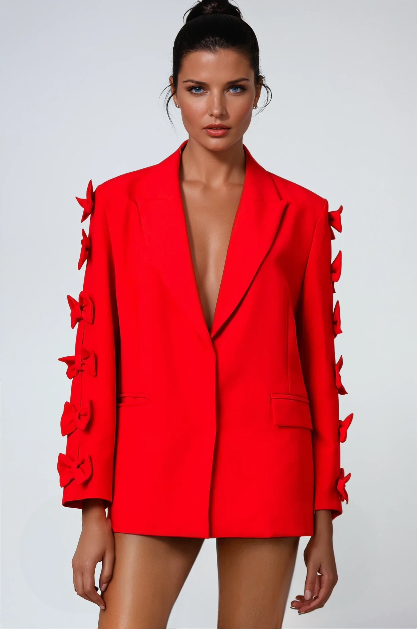 Elegant red blazer with bow details on sleeves