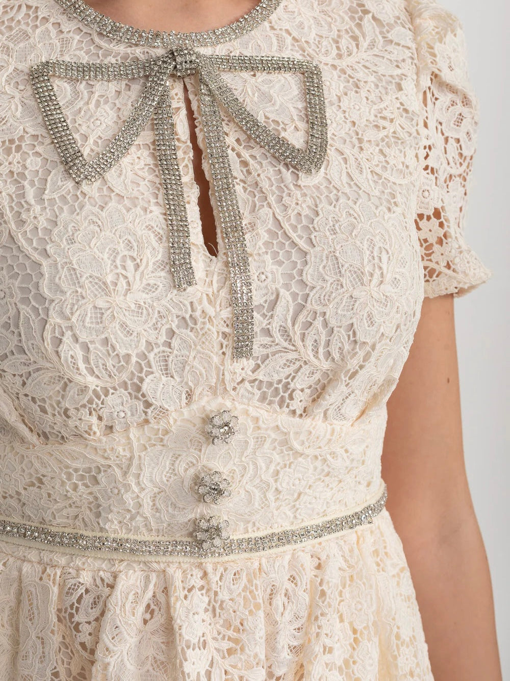 Ivoire Short Sleeved Lace Dress With Rounded Neckline And Decorative Bow